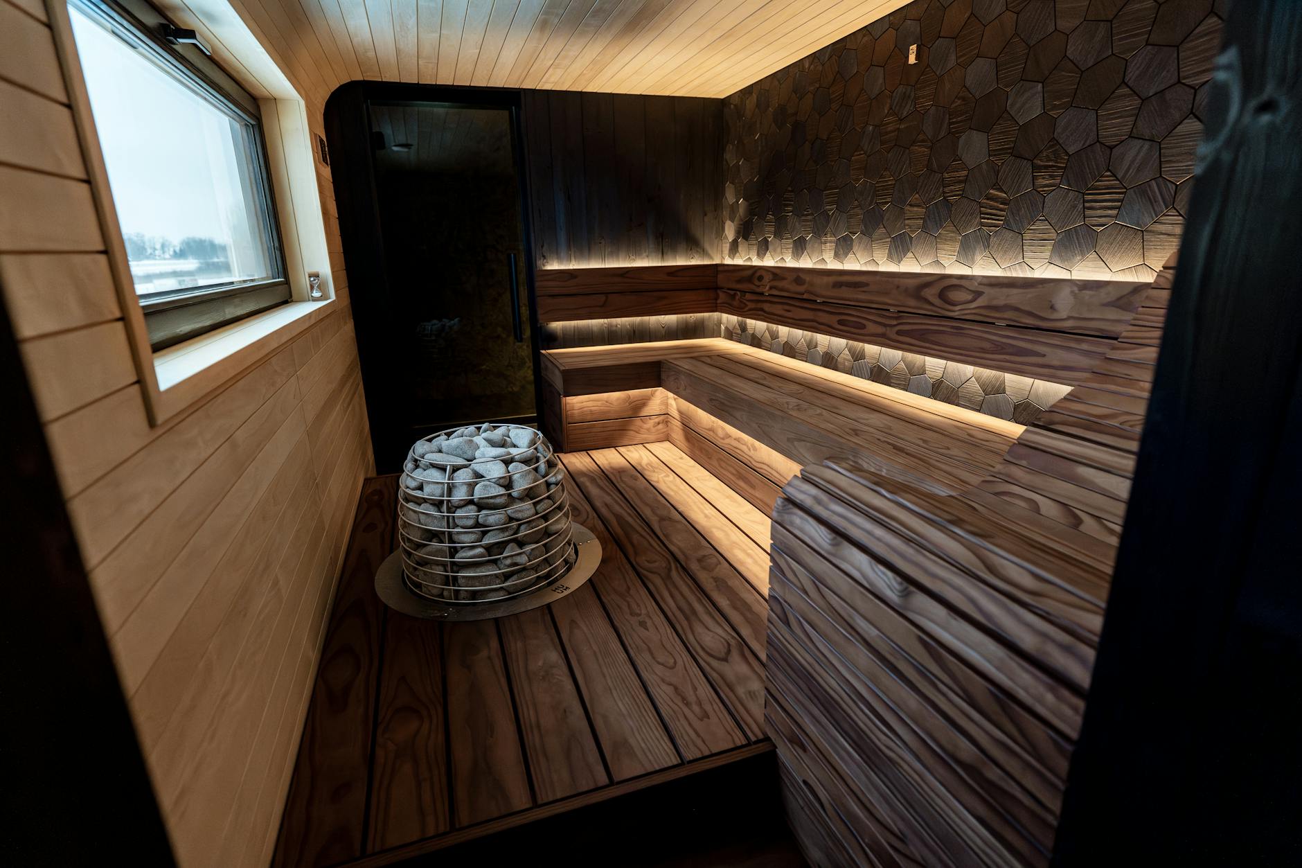 A beautifully designed indoor sauna featuring wood panels and LED lighting, showcasing Nordic aesthetics.