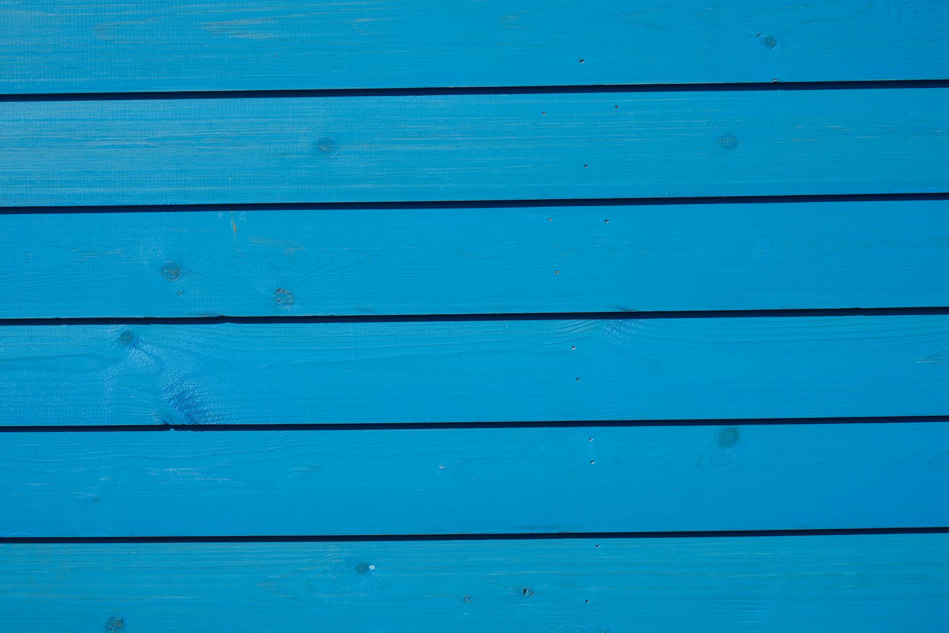Close-up of vibrant blue wooden paneling with a detailed texture, ideal for backgrounds.