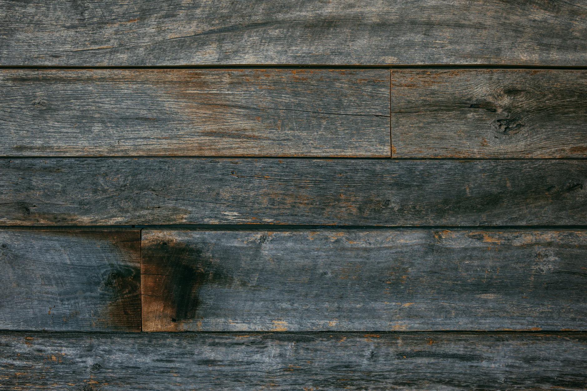 A detailed close-up of a rustic wooden plank wall showcasing natural texture and grain.