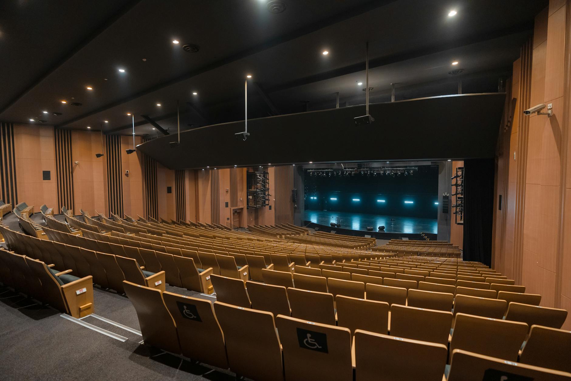 Empty auditorium with seating and stage lighting, Varanasi.