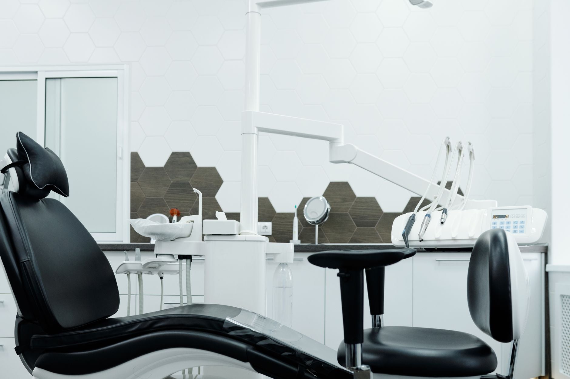 Clean and organized dental office featuring a modern dental chair and equipment.