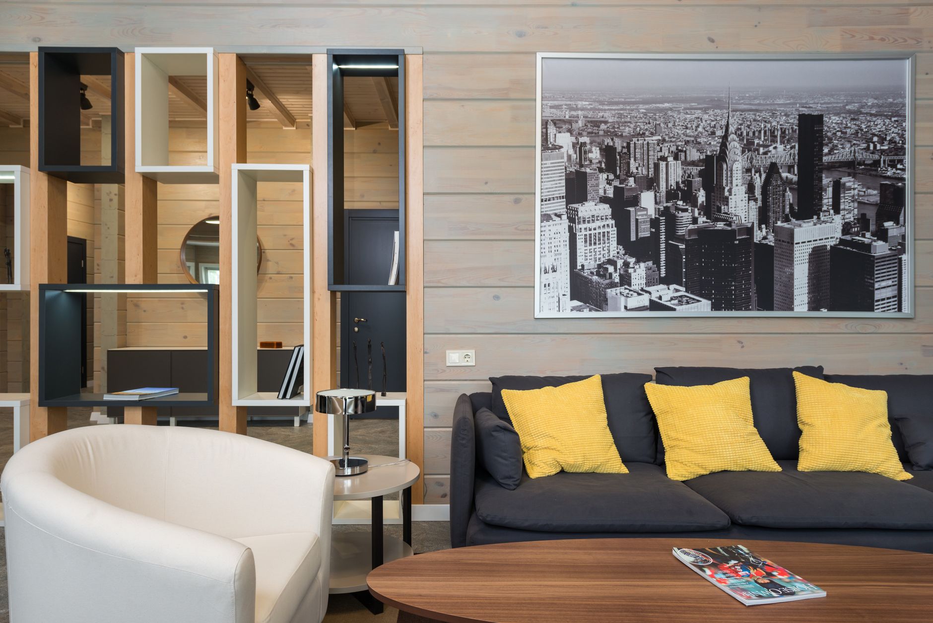 Stylish modern living room featuring a sleek design with urban-themed artwork and contemporary furniture.