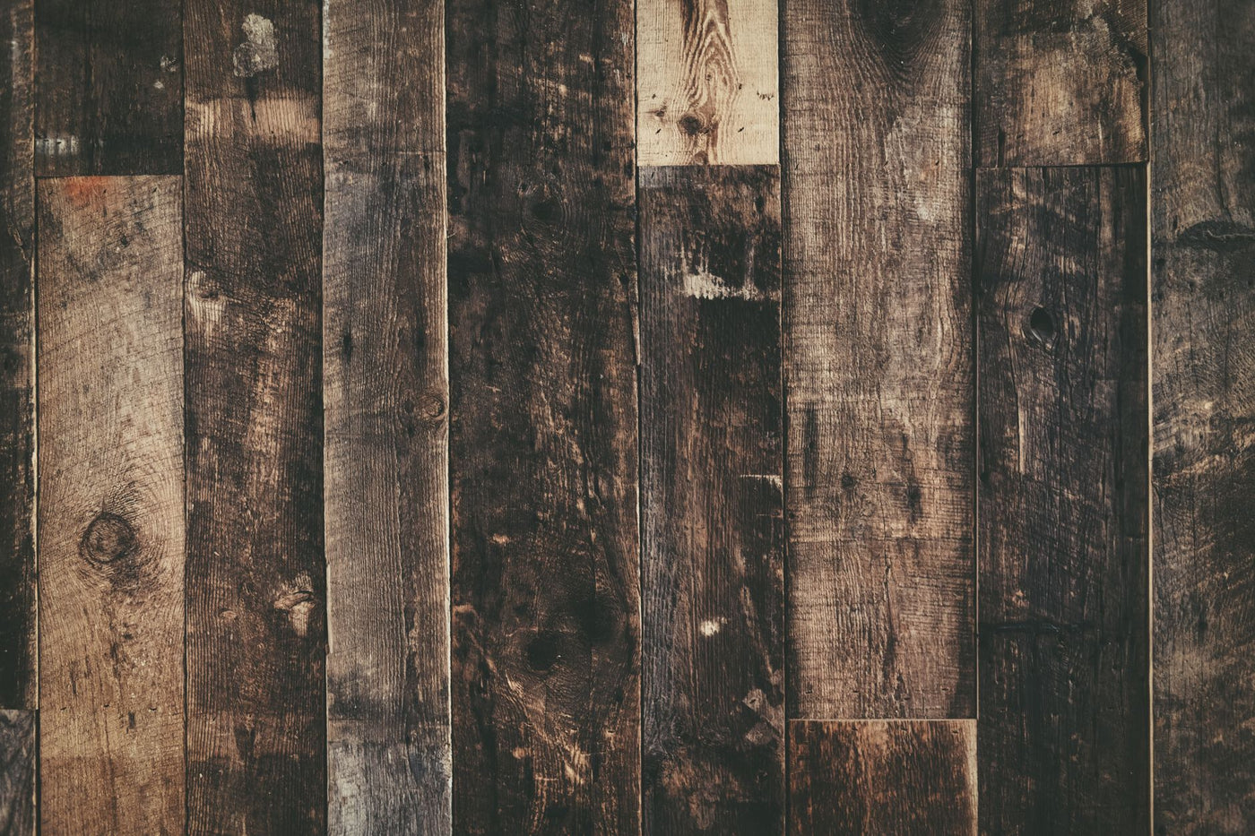 Close-up of weathered rustic wooden planks creating a dark textured background.