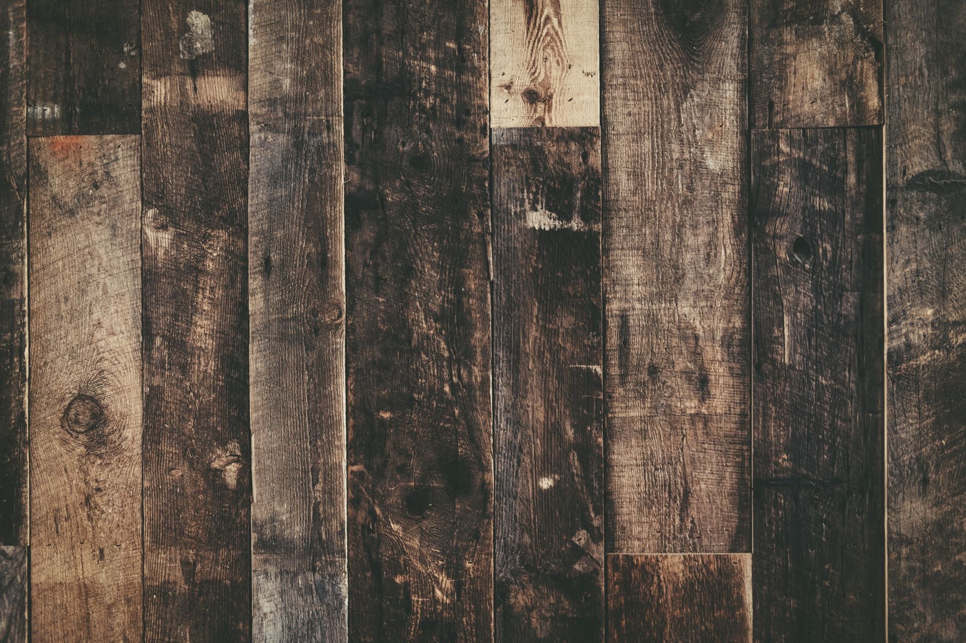 Close-up of weathered rustic wooden planks creating a dark textured background.