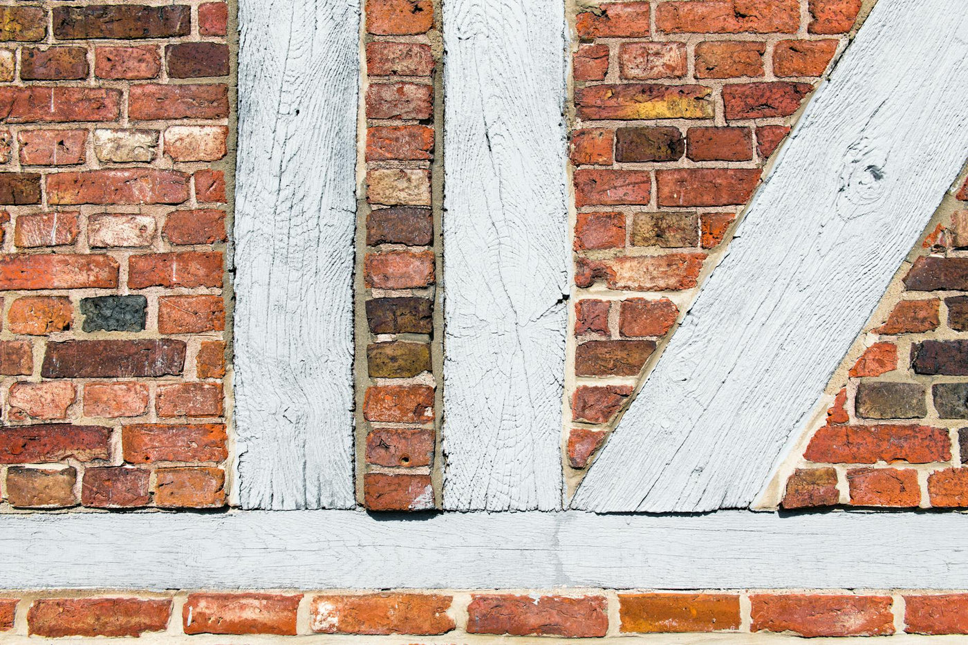 Close-up of a timber-framed red brick wall in Geesthacht, Germany showcasing old architecture.