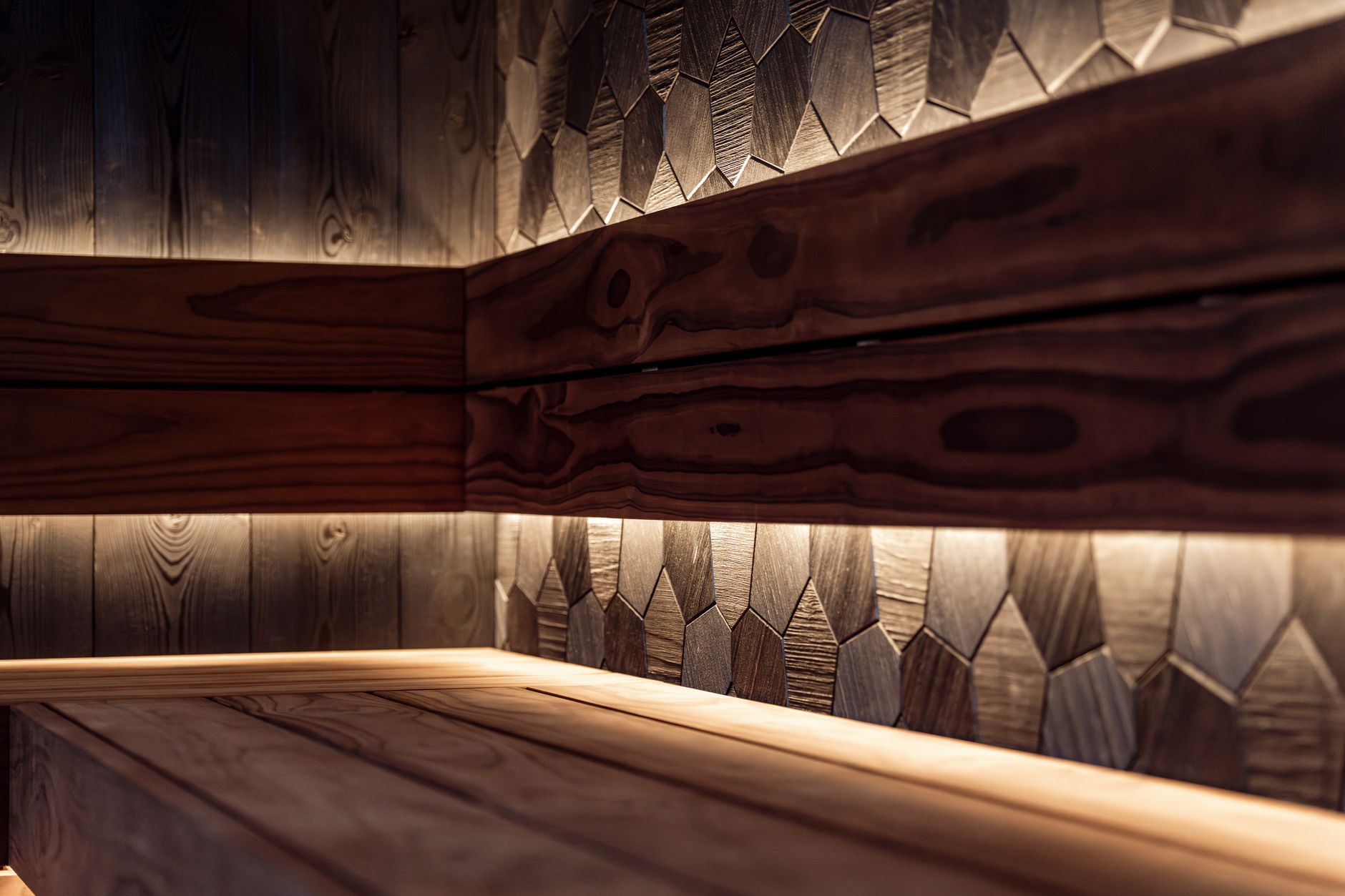 A sleek Nordic-style sauna interior featuring wood paneling and modern LED lighting.