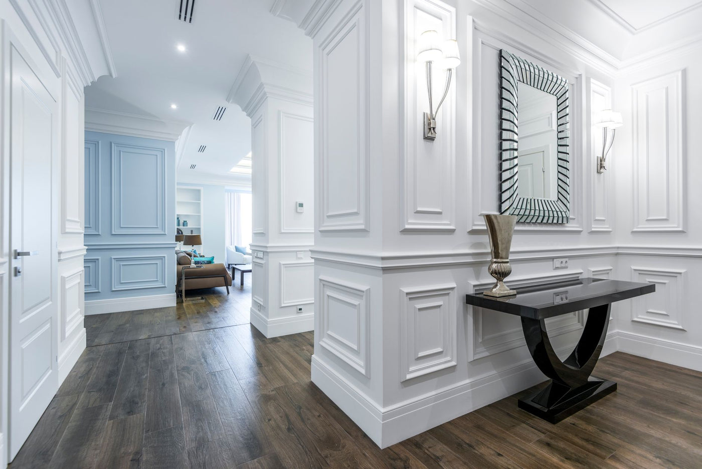 Luxurious hallway with modern decor and wooden floor, showcasing minimalism.