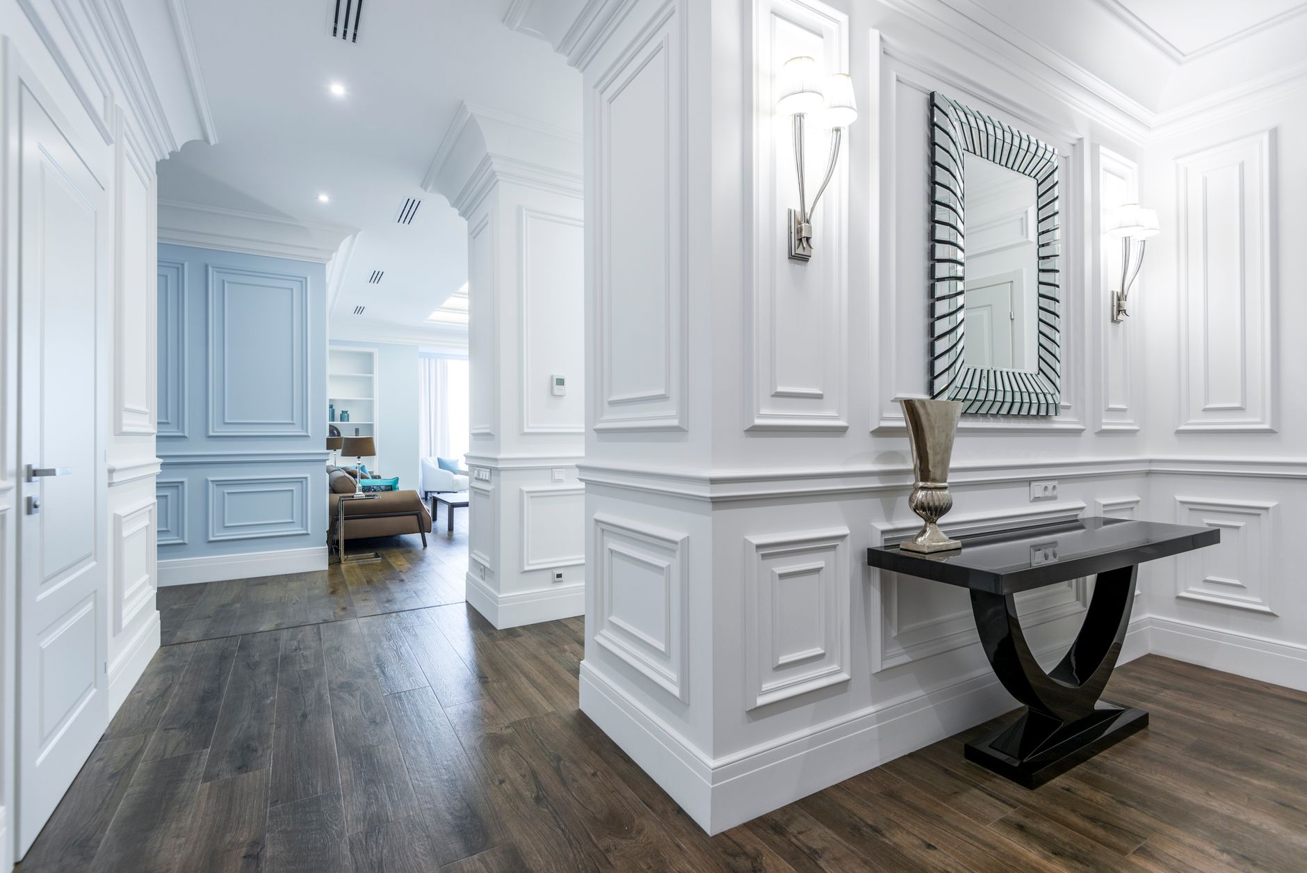 Luxurious hallway with modern decor and wooden floor, showcasing minimalism.