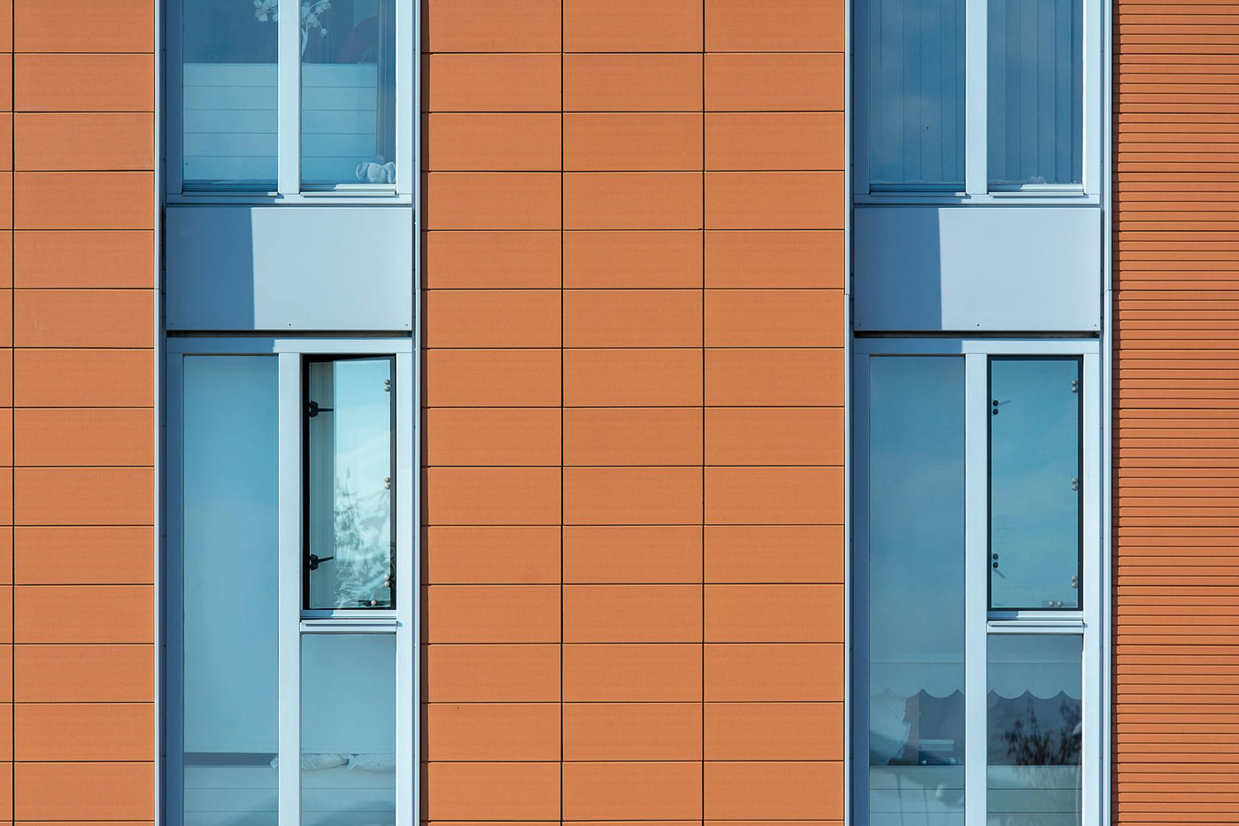 Close-up of a building facade featuring bold rectangular patterns and large windows.