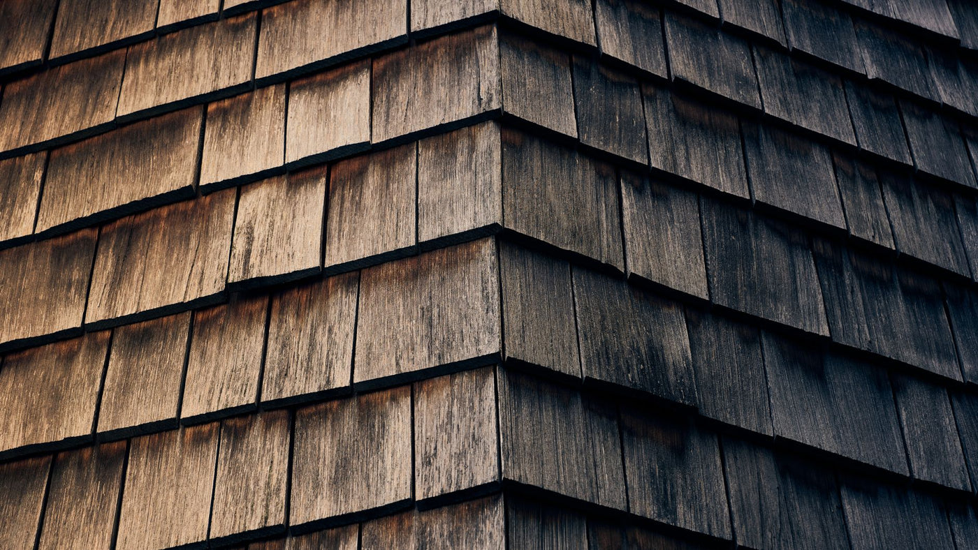 Detailed view of textured wooden shingles with a natural warm finish.